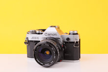 Load image into Gallery viewer, Canon AE-1 35mm Film SLR Camera with Sigma Mini-Wide II 28mm f/2.8 Lens