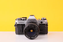 Load image into Gallery viewer, Canon AE-1 35mm Film SLR Camera with Sigma Mini-Wide II 28mm f/2.8 Lens