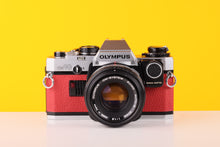 Load image into Gallery viewer, Olympus OM10 35mm Film Camera with Zuiko 50mm f1.8 Prime Lens Red Leather Skin and Adapter