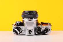 Load image into Gallery viewer, Olympus OM10 35mm SLR Film Camera with Manual Adapter and Olympus Zuiko Auto-S 50mm f1.8