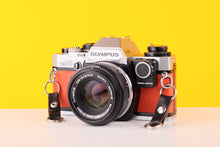 Load image into Gallery viewer, Olympus OM10 35mm SLR Film Camera with Manual Adapter and Olympus Zuiko Auto-S 50mm f1.8 Lens Orange