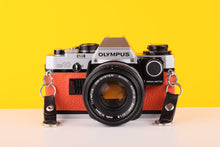 Load image into Gallery viewer, Olympus OM10 35mm SLR Film Camera with Manual Adapter and Olympus Zuiko Auto-S 50mm f1.8 Lens in Orange