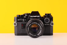 Load image into Gallery viewer, Olympus OM10 Black 35mm SLR Film Camera with Olympus OM-System Zuiko MC Auto-S 50mm f1.8 Lens and Manual Adapter