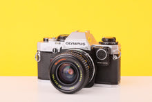 Load image into Gallery viewer, Olympus OM10 35mm Film Camera with 28mm f2.8 MC Lens with Manual Adapter