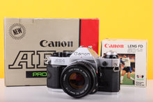 Load image into Gallery viewer, Canon AE-1 Program 35mm SLR Film Camera with Canon FD 50mm f/1.8 Lens – Boxed