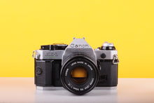 Load image into Gallery viewer, Canon AE-1 Program 35mm SLR Film Camera with Canon FD 50mm f/1.8 Lens – Boxed