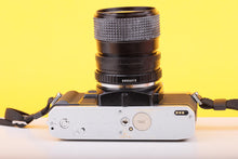 Load image into Gallery viewer, Minolta X-300 35mm SLR Film Camera with Minolta MD Zoom 28–70mm f/3.5–4.8 Lens