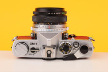 Load image into Gallery viewer, Olympus OM-1 35mm Film Camera with Olympus 28mm f/2.8 Prime Lens in Red