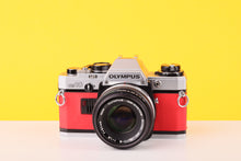 Load image into Gallery viewer, Olympus OM10 35mm SLR Film Camera with Olympus F.Zuiko Auto-S 50mm f1.8 Lens in Scarlet Red