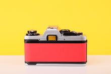 Load image into Gallery viewer, Olympus OM10 35mm SLR Film Camera with Olympus F.Zuiko Auto-S 50mm f1.8 Lens in Scarlet Red