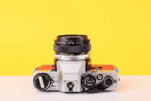 Load image into Gallery viewer, Olympus OM10 35mm SLR Film Camera with Olympus F.Zuiko Auto-S 50mm f1.8 Lens in Scarlet Red