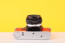 Load image into Gallery viewer, Olympus OM10 35mm SLR Film Camera with Olympus F.Zuiko Auto-S 50mm f1.8 Lens in Scarlet Red