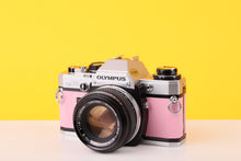 Load image into Gallery viewer, Olympus OM10 35mm SLR Film Camera with Olympus F.Zuiko Auto-S 50mm f1.8 Lens in Bubble Gum Pink