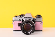 Load image into Gallery viewer, Olympus OM10 35mm SLR Film Camera with Olympus F.Zuiko Auto-S 50mm f1.8 Lens in Bubble Gum Pink