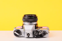 Load image into Gallery viewer, Olympus OM10 35mm SLR Film Camera with Olympus F.Zuiko Auto-S 50mm f1.8 Lens in Bubble Gum Pink