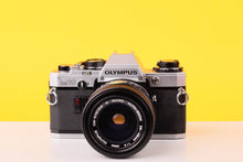 Load image into Gallery viewer, Olympus OM10 35mm SLR Film Camera with Olympus OM-System S Zuiko Auto-Zoom 28-48mm f4 Lens