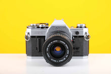 Load image into Gallery viewer, Canon AE-1 35mm SLR Film Camera with Canon Zoom FD 35-70mm f3.5-4.5 Lens