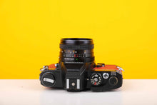 Load image into Gallery viewer, Konica Autoreflex TC 35mm SLR Film Camera with Konica Hexanon AR 28mm f3.5 Prime Lens in Red