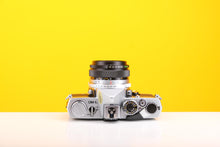 Load image into Gallery viewer, Olympus OM-1n SLR 35mm Film Camera with Olympus OM-System G.Zuiko Auto-W 28mm f3.5 Lens