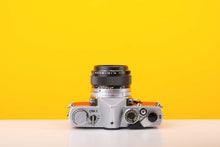 Load image into Gallery viewer, Olympus OM-1 35mm Film Camera with Olympus 50mm f/1.4 Prime Lens in Red