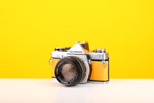 Load image into Gallery viewer, Olympus OM-2 35mm SLR Film Camera with Zuiko Olymplus OM-System G.Zuiko Auto-S 50mm f1.4 Lens in Yellow