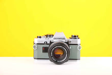Load image into Gallery viewer, Olympus OM10 35mm Film Camera with Olympus Zukio Auto-S 50mm f1.8 Lens in Turquoise