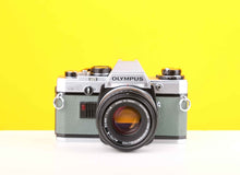 Load image into Gallery viewer, Olympus OM10 35mm Film Camera with Olympus Zuiko Auto-S 50mm f1.8 Lens in Safari Green