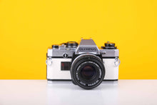 Load image into Gallery viewer, Olympus OM10 35mm Film Camera with Olympus OM-System Zukio Auto-S 50mm f1.8 Lens in New White Leather Skin