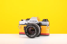 Load image into Gallery viewer, Olympus OM10 Slr Vintage 35mm Film Camera with Zuiko 50mm f1.8 Prime Lens and with New Leather Yellow and Red Skin