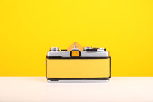 Load image into Gallery viewer, Olympus OM-1 35mm SLR Film Camera with Olympus OM-System Zuiko Auto-S 50mm f1.8 Lens in Yellow