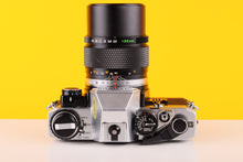 Load image into Gallery viewer, Olympus OM10 35mm SLR Film Camera with Manual Adapter and Olympus OM-System E.Zuiko Auto-T 135mm f3.5 Lens
