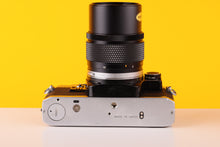 Load image into Gallery viewer, Olympus OM10 35mm SLR Film Camera with Manual Adapter and Olympus OM-System E.Zuiko Auto-T 135mm f3.5 Lens
