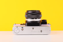 Load image into Gallery viewer, Olympus OM10 35mm SLR Film Camera with Manual Adapter and Olympus Zuiko MC Auto-S 50mm f1.8 Lens in Lilac