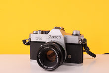 Load image into Gallery viewer, Canon TX 35mm SLR Film Camera + Canon FD 50mm f/1.8 S.C. Lens