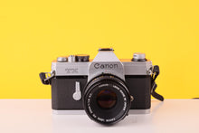 Load image into Gallery viewer, Canon TX 35mm SLR Film Camera + Canon FD 50mm f/1.8 S.C. Lens