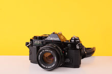 Load image into Gallery viewer, Canon AE-1 Program Black 35mm Film Camera with Canon FD 50mm f/1.8 Lens