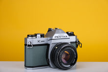 Load image into Gallery viewer, Pentax K1000 35mm Film Camera with SMC Pentax M 50mm f/1.7 Prime Lens and New Grey Leather Skin