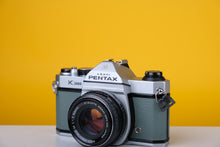 Load image into Gallery viewer, Pentax K1000 35mm Film Camera with SMC Pentax M 50mm f/1.7 Prime Lens and New Grey Leather Skin