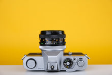 Load image into Gallery viewer, Canon TX 35mm SLR Film Camera with Canon FD 50mm f/1.8 Prime lens