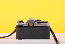 Load image into Gallery viewer, Olympus OM10 35mm Film SLR Camera with Olympus E.Zuiko Auto-T 135mm f/3.5 Lens
