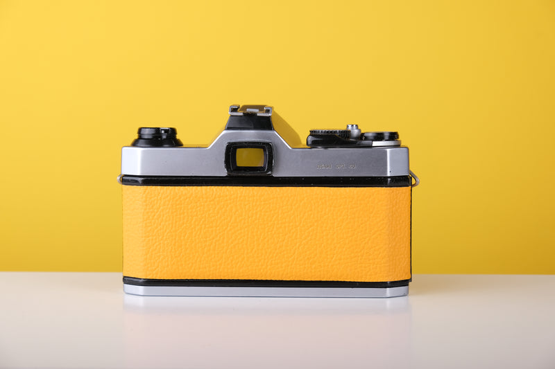 Pentax K1000 35mm Film Camera with Pentax 50mm f/2 Lens in Yellow