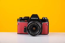 Load image into Gallery viewer, Konica Autoreflex TC 35mm SLR Film Camera with Konica Hexanon 28mm f3.5 Prime Lens in Red
