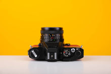 Load image into Gallery viewer, Konica Autoreflex TC 35mm SLR Film Camera with Konica Hexanon 28mm f3.5 Prime Lens in Red
