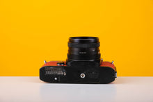 Load image into Gallery viewer, Konica Autoreflex TC 35mm SLR Film Camera with Konica Hexanon 28mm f3.5 Prime Lens in Red
