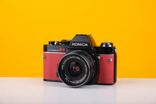 Load image into Gallery viewer, Konica Autoreflex TC 35mm SLR Film Camera with Konica Hexanon 28mm f3.5 Prime Lens in Red
