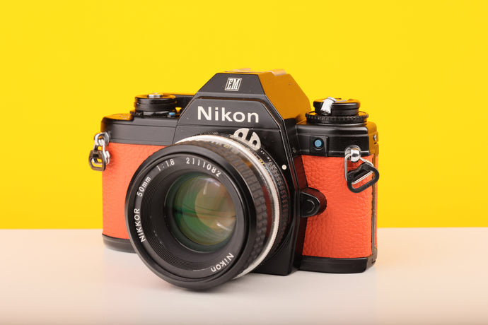 Nikon Em camera with orange body 