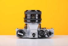 Load image into Gallery viewer, Olympus OM10 35mm SLR Film Camera in Yellow with Tamron 28mm f/2.8 Prime Lens
