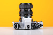 Load image into Gallery viewer, Olympus OM10 35mm SLR Film Camera in Yellow with Tokina 28-70mm f/3.5-4.5 Zoom Lens
