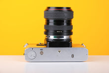 Load image into Gallery viewer, Olympus OM10 35mm SLR Film Camera in Yellow with Tokina 28-70mm f/3.5-4.5 Zoom Lens
