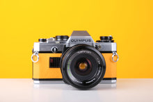 Load image into Gallery viewer, Olympus OM10 35mm SLR Film Camera in Yellow with Tamron 28mm f/2.8 Prime Lens
